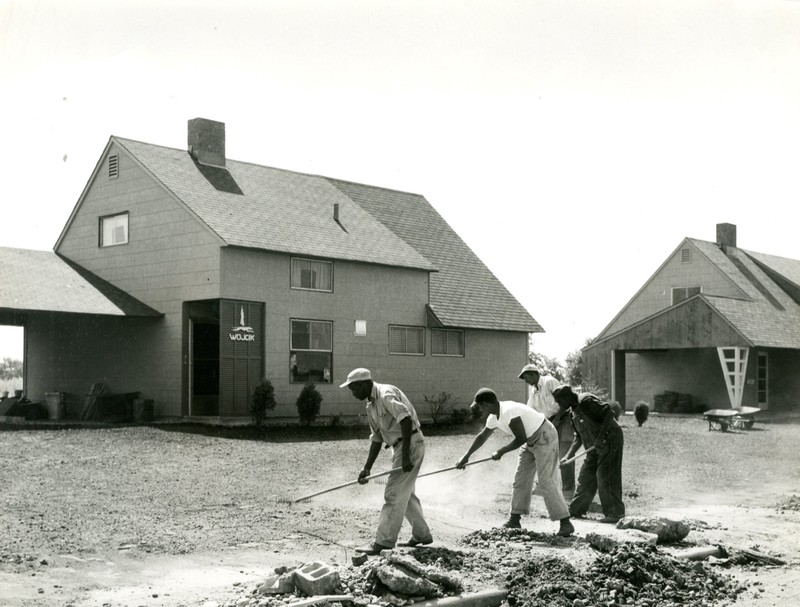 Crews working on lawn of completed Levitt house