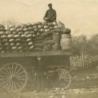 Fully loaded market wagon with unidentified worker on top and another standing alongside of the wagon.jpg