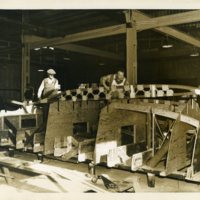 Two Men Shaping Boat Bracings