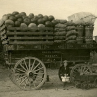 Leon A. Rushmore, Jr., standing in front of a fully loaded market wagon at Rushmore Farms, c.1914.jpg