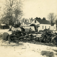 Unidentified men loading winter wood onto wood pile at Rushmore Farms, c. Winter 1918.jpg