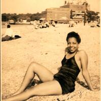 4-9. Woman wearing a bathing suit, sitting on Tappan Beach, Glenwood Landing, 1943.jpg